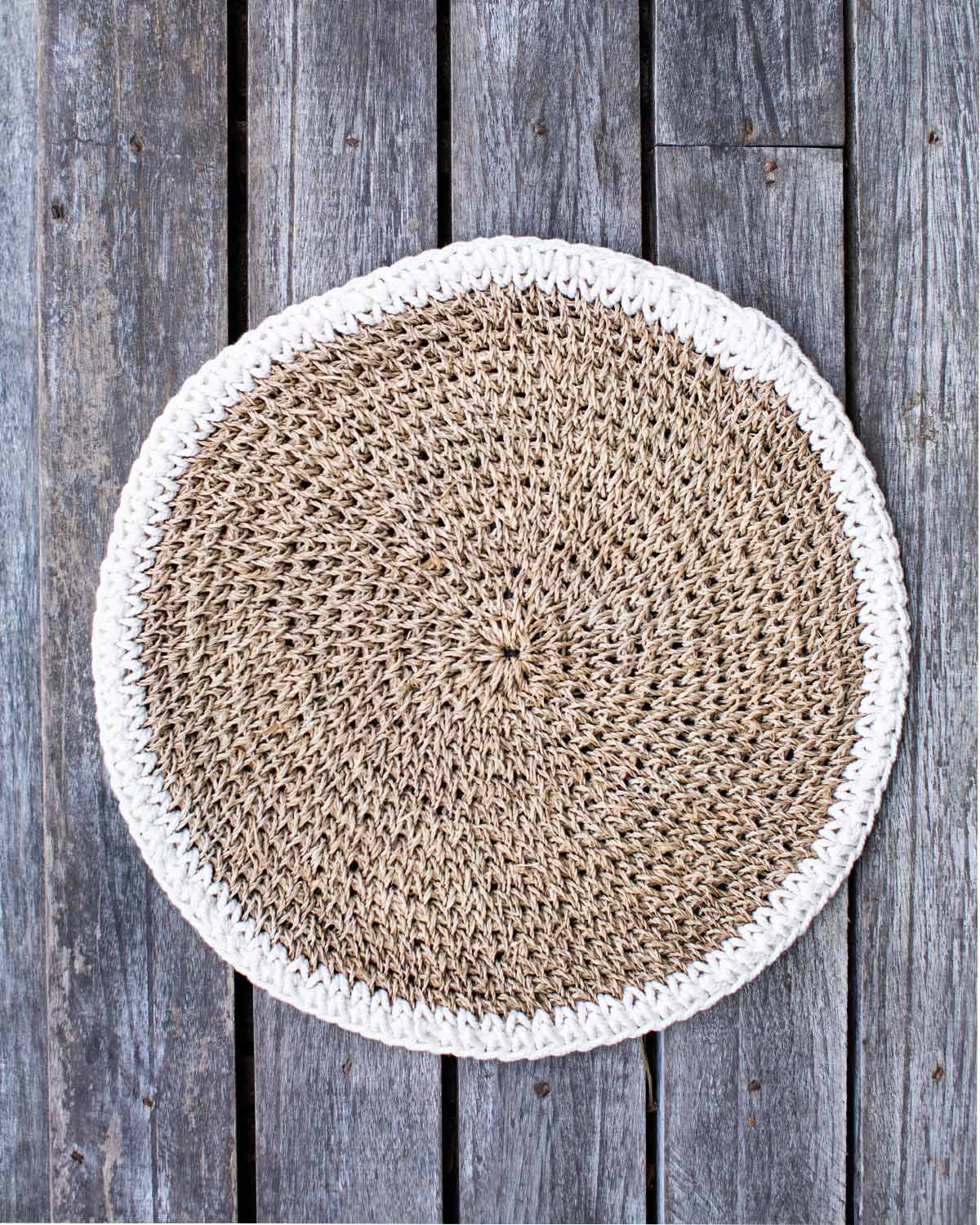 Woven placemat edged in white.