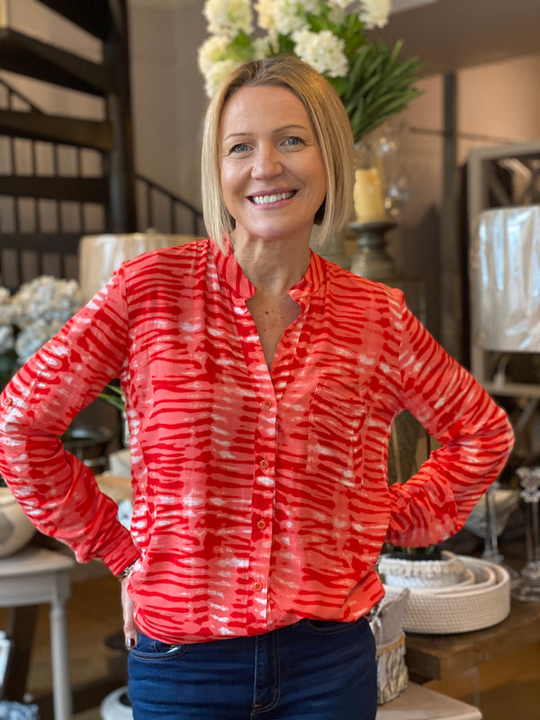 Emma in our Eden shirt style top in a red and white tie dye print.