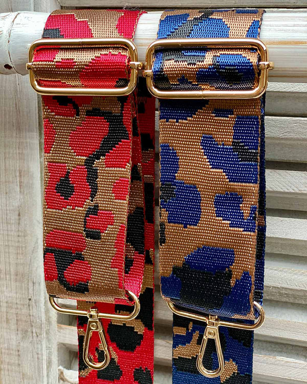 Two animal bag straps one red cheetah print and blue cheetah print.