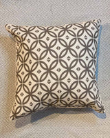 Beige geometric print cushion covers printed on a cream cotton fabric.