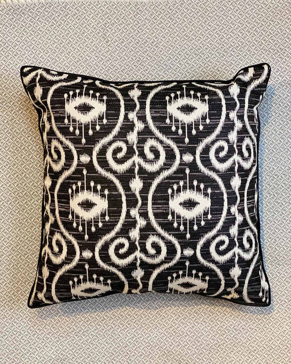 Black and white batik patterned cushion cover.