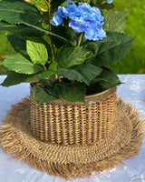 Raffia centre placemat, with rattan vase and hydrangea in the middle.
