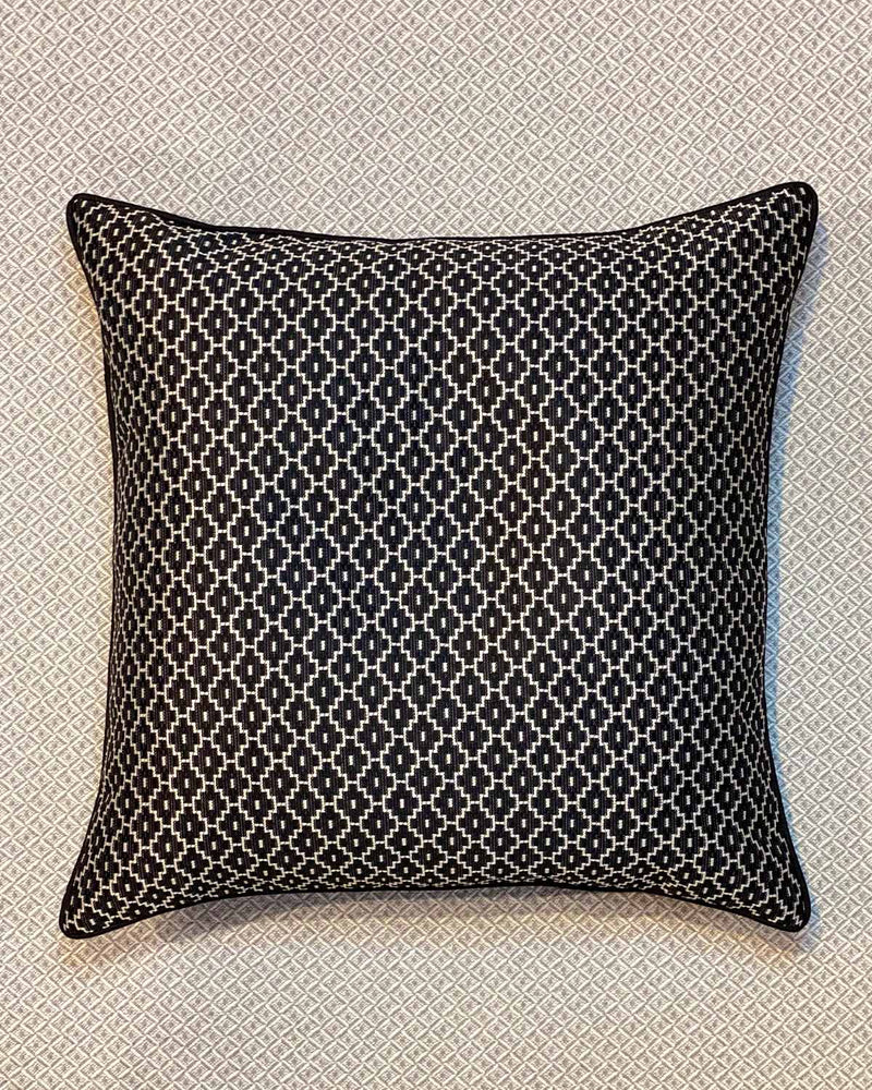Large cushion printed in a black and white domino print.