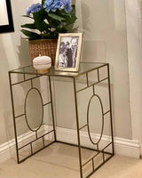 Metal structure side table with glass top.