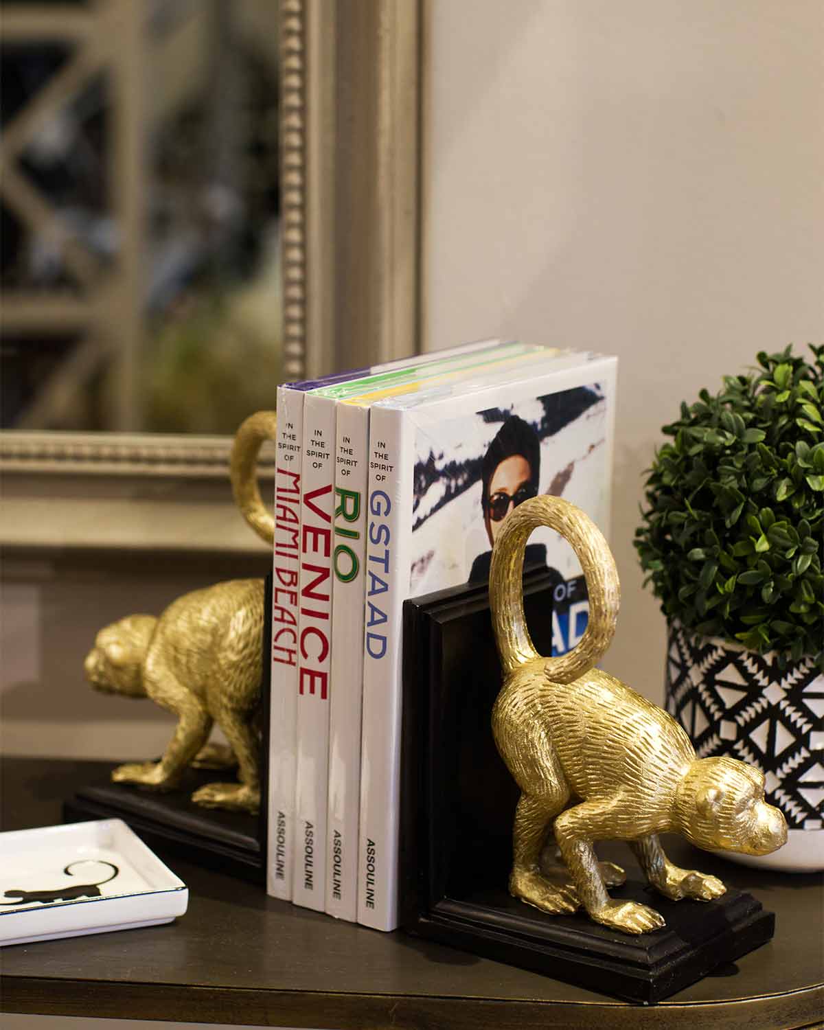 Large gold monkeys on black wooden bookends. 