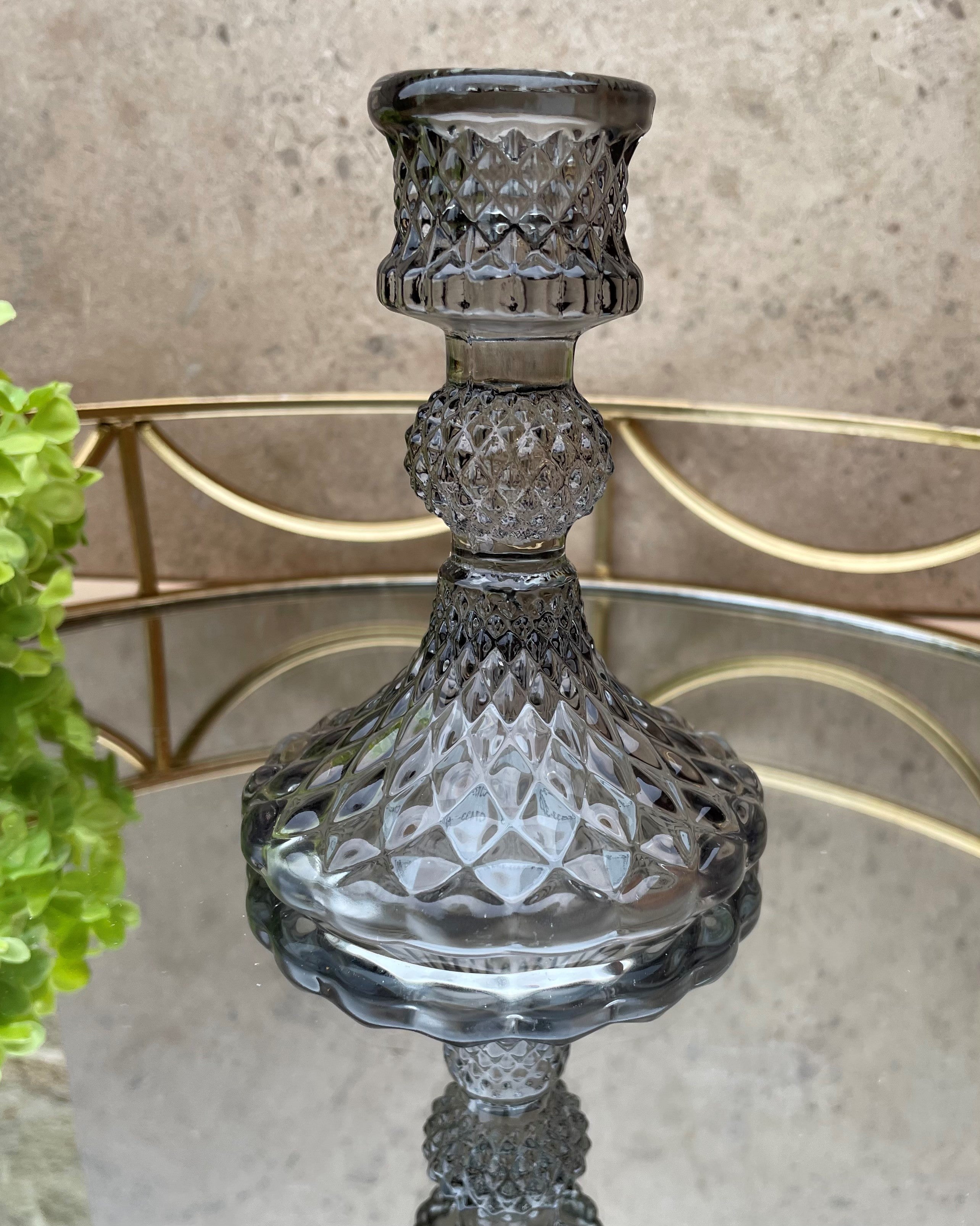 Grey glass candlestick holder.