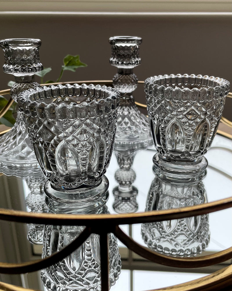 Grey glass tea light holders with matching candlestick holders.