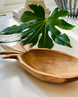 Wooden pineapple dish, showing side details with green leaf.