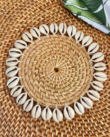 Natural rattan coaster edged with sea shells.