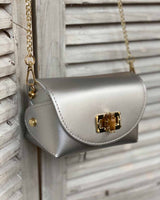 Silver cross body bag with gold bamboo clasp. With attachable gold chain.