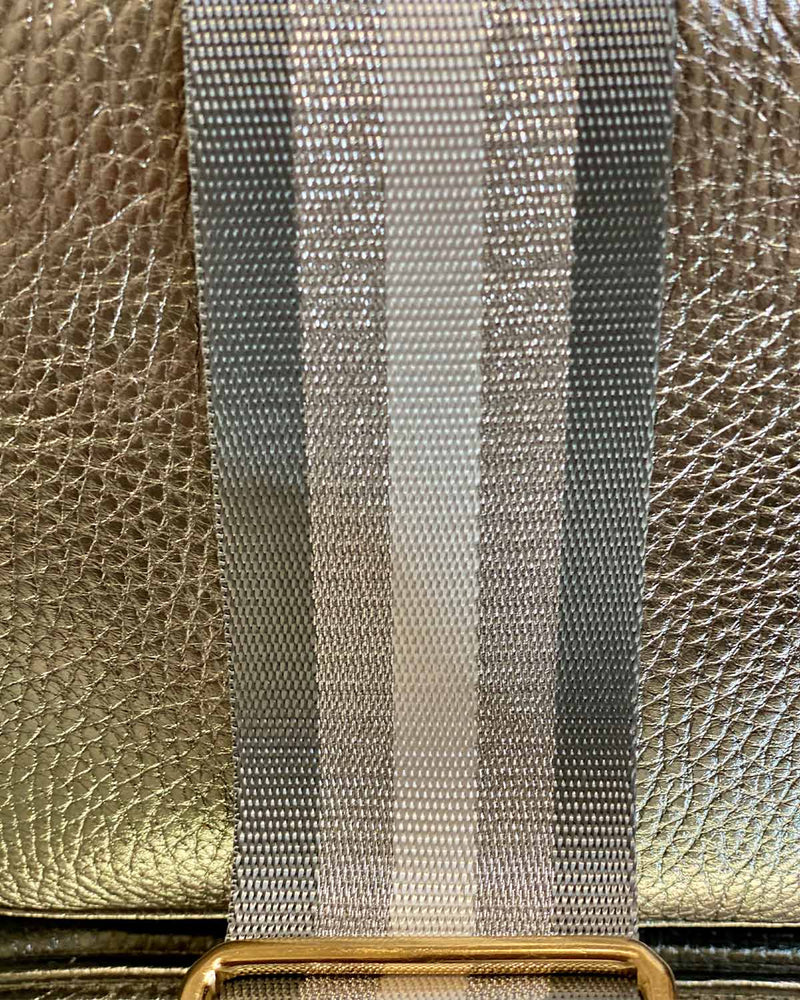 Close up image of grey/silver stripe bag strap.
