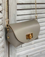 Taupe cross body bag with gold bamboo clasp. With adjustable clasps on the sides.