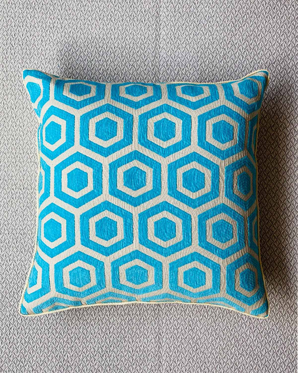 Close up of cushion cover in turquoise and cream geometric print.