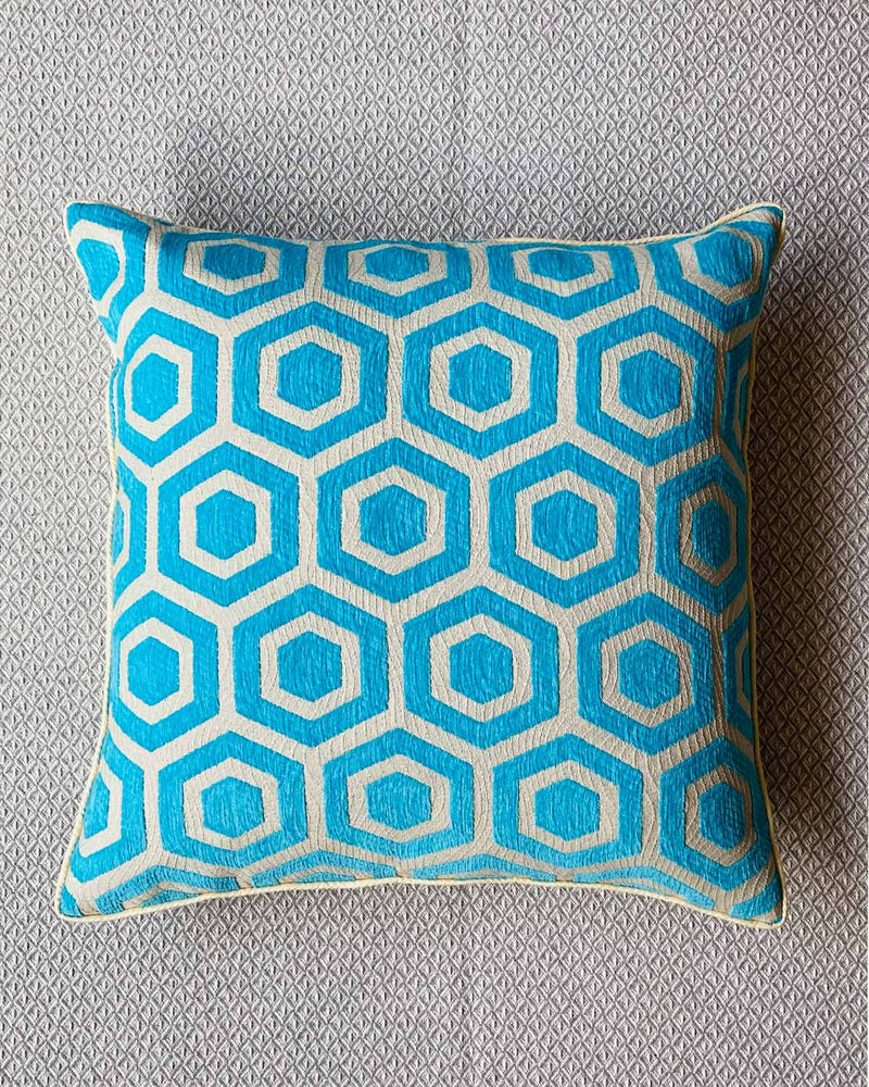 Close up of cushion cover in turquoise and cream geometric print.