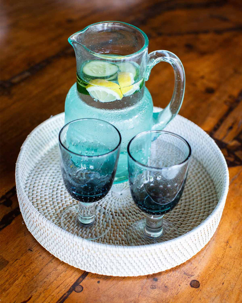 White rattan tray in use with a jug and two glasses of water.