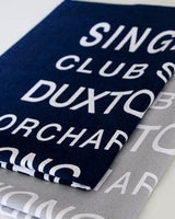 One navy and one grey tea towel, printed with white writing.