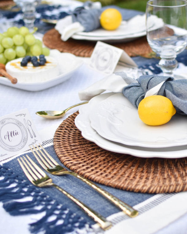 Natural rattan placemat, pictured at a dining setting.